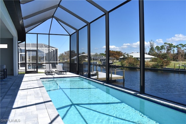 view of swimming pool featuring a patio, a water view, and glass enclosure