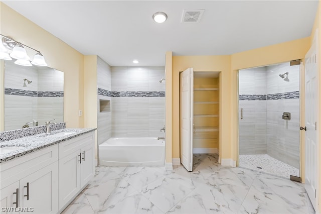 bathroom with double sink vanity, plus walk in shower, and tile floors