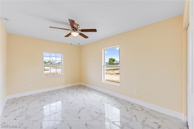 spare room featuring ceiling fan and light tile flooring