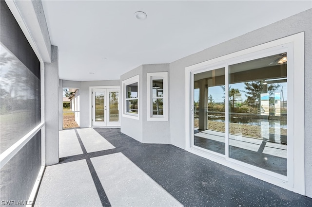 unfurnished sunroom with french doors