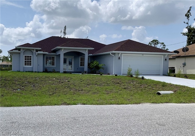 ranch-style house featuring a front lawn and a garage