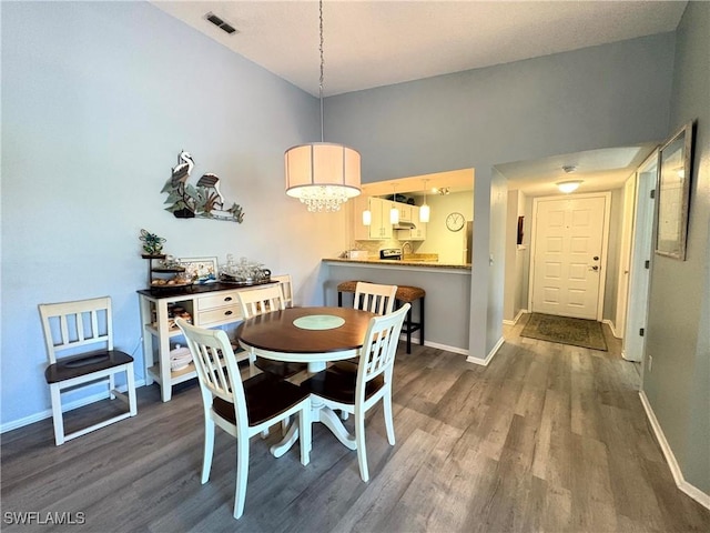 14861 Summerlin Woods Dr Unit 13, Fort Myers, FL 33919 - dining room featuring dark wood-type flooring, baseboards, visible vents, and a chandelier