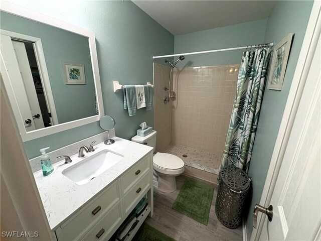 14861 Summerlin Woods Dr Unit 13, Fort Myers, FL 33919 - bathroom with vanity, wood finished floors, a shower stall, and toilet