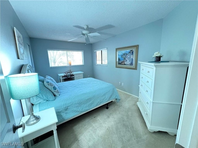 14861 Summerlin Woods Dr Unit 13, Fort Myers, FL 33919 - bedroom with light carpet, a textured ceiling, and a ceiling fan