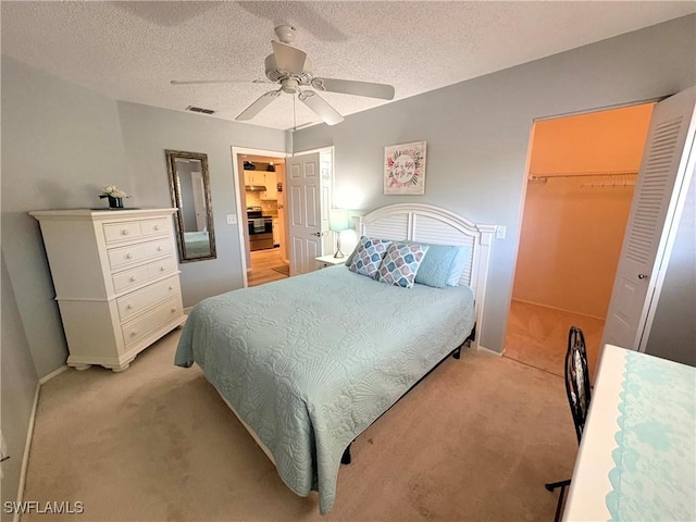 14861 Summerlin Woods Dr Unit 13, Fort Myers, FL 33919 - bedroom featuring a closet, light carpet, a textured ceiling, and a walk in closet