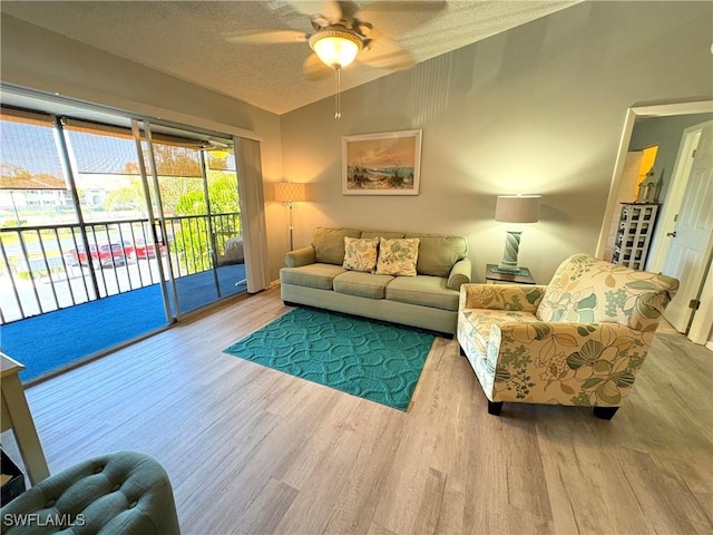 14861 Summerlin Woods Dr Unit 13, Fort Myers, FL 33919 - living area with a textured ceiling, a ceiling fan, lofted ceiling, and wood finished floors