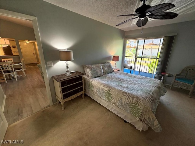 14861 Summerlin Woods Dr Unit 13, Fort Myers, FL 33919 - carpeted bedroom featuring ceiling fan, a textured ceiling, access to exterior, and vaulted ceiling