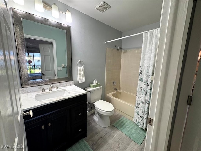 14861 Summerlin Woods Dr Unit 13, Fort Myers, FL 33919 - full bathroom featuring vanity, shower / bathtub combination with curtain, wood finished floors, visible vents, and toilet