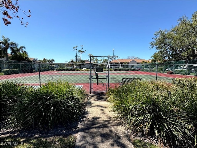 14861 Summerlin Woods Dr Unit 13, Fort Myers, FL 33919 - view of tennis court with a gate and fence