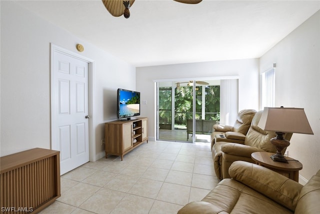 tiled living room with ceiling fan