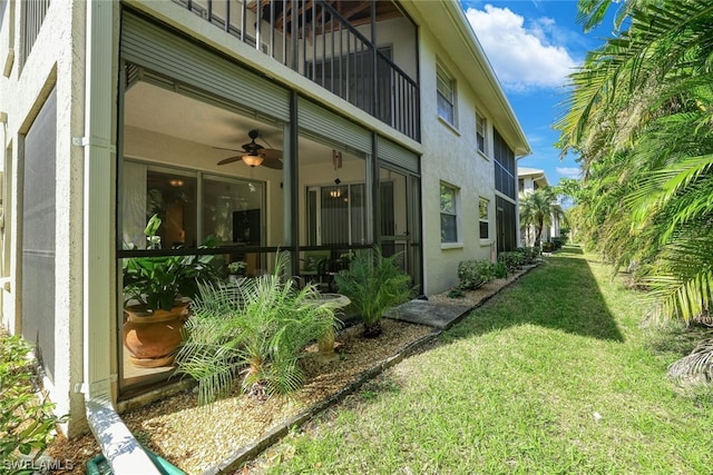 exterior space with ceiling fan