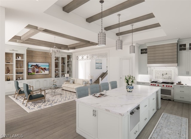 kitchen featuring decorative light fixtures, built in shelves, a kitchen island, high end stainless steel range, and white cabinets