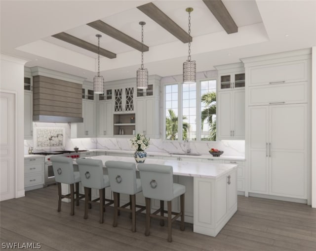 kitchen featuring dark hardwood / wood-style floors, sink, white cabinetry, and a large island