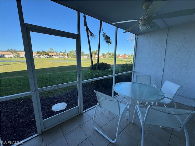 sunroom with a healthy amount of sunlight and ceiling fan