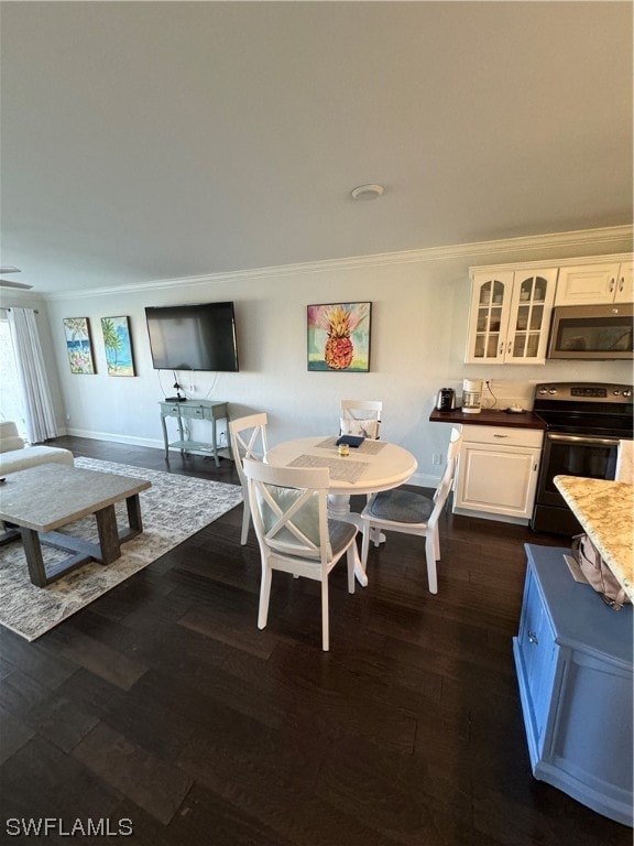 dining space featuring ornamental molding and dark wood-type flooring