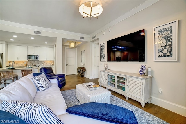 living room featuring dark hardwood / wood-style floors and ornamental molding