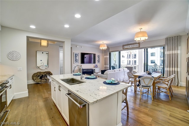 kitchen featuring white cabinetry, stainless steel appliances, sink, and light hardwood / wood-style flooring