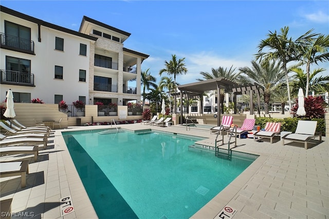 view of pool with a pergola and a patio