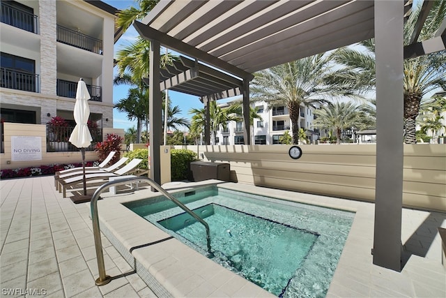 view of swimming pool with a hot tub, a pergola, and a patio