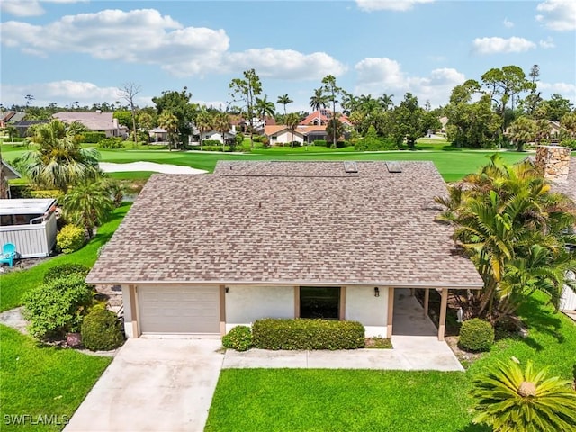 view of front of property with a front yard and a carport