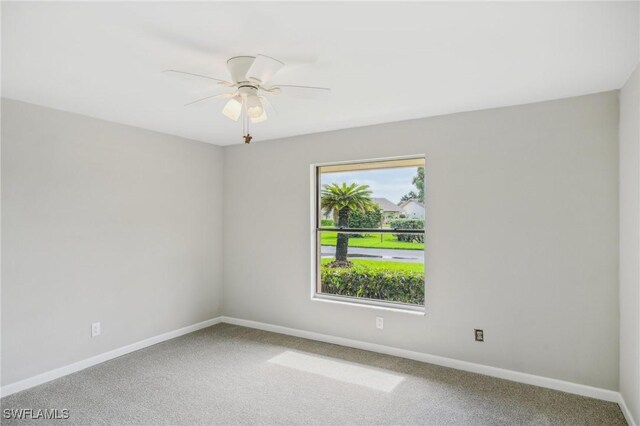 empty room featuring carpet flooring and ceiling fan