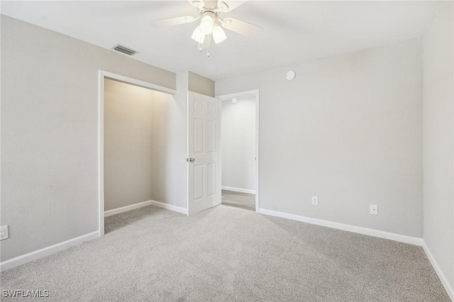 unfurnished bedroom featuring ceiling fan and light carpet