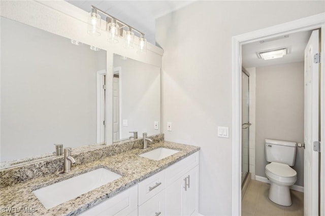 bathroom with tile patterned flooring, vanity, toilet, and walk in shower