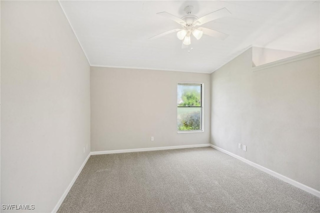 spare room featuring ceiling fan, lofted ceiling, and carpet