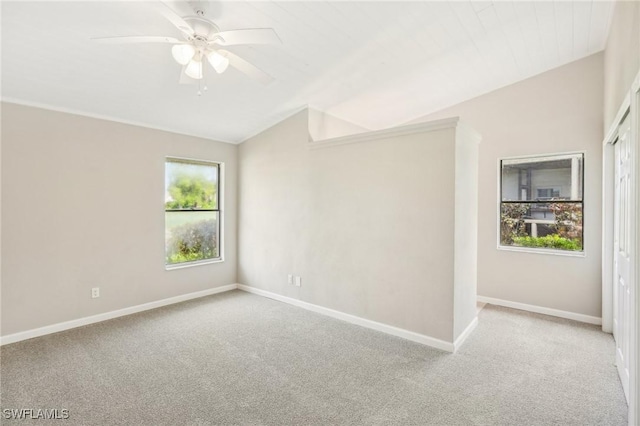 unfurnished room with vaulted ceiling, light colored carpet, and ceiling fan