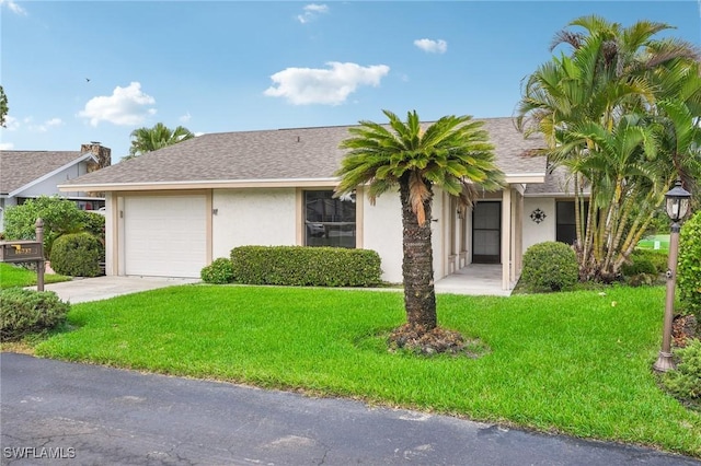 view of front of property featuring a garage and a front yard