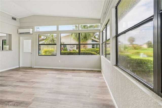 unfurnished sunroom with vaulted ceiling and a wall unit AC