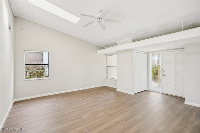 interior space with a skylight, ceiling fan, hardwood / wood-style floors, and wood ceiling