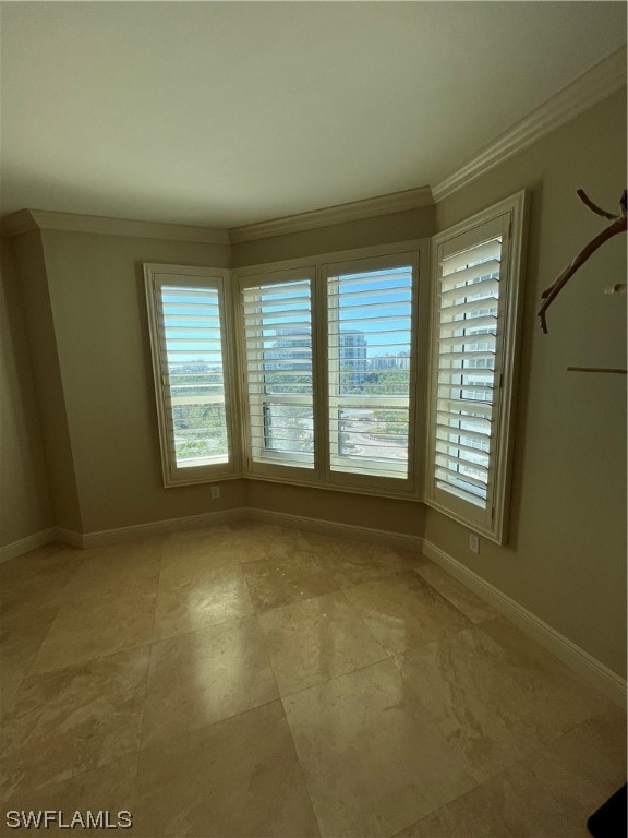 empty room featuring light tile floors and ornamental molding