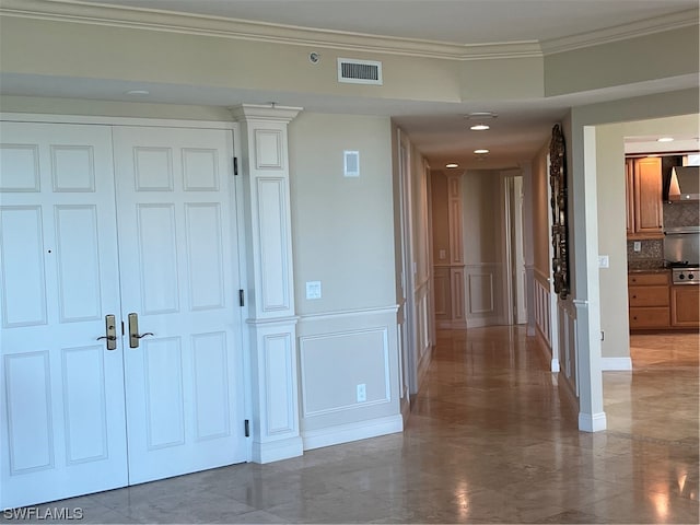 corridor featuring dark tile floors and crown molding