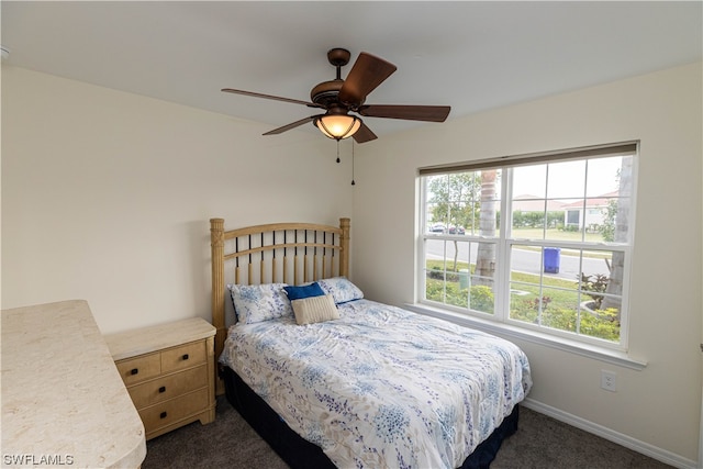 bedroom featuring ceiling fan and dark carpet