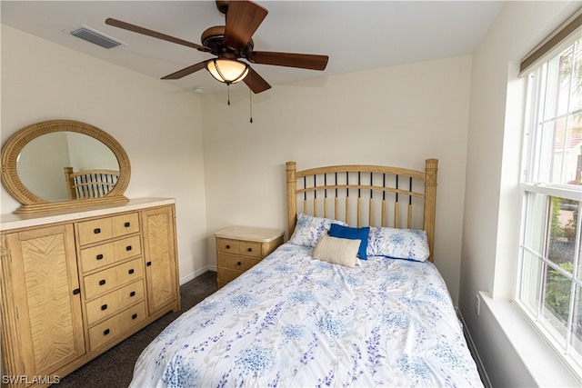 bedroom with dark colored carpet and ceiling fan