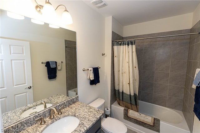 full bathroom featuring shower / tub combo, toilet, and vanity with extensive cabinet space