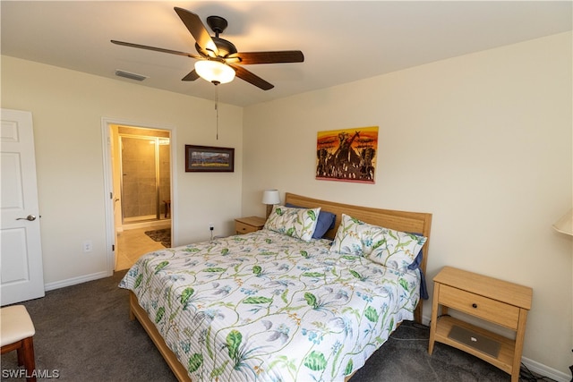 bedroom featuring ceiling fan, dark carpet, and ensuite bathroom