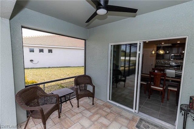 sunroom / solarium featuring ceiling fan