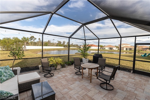 sunroom featuring a water view