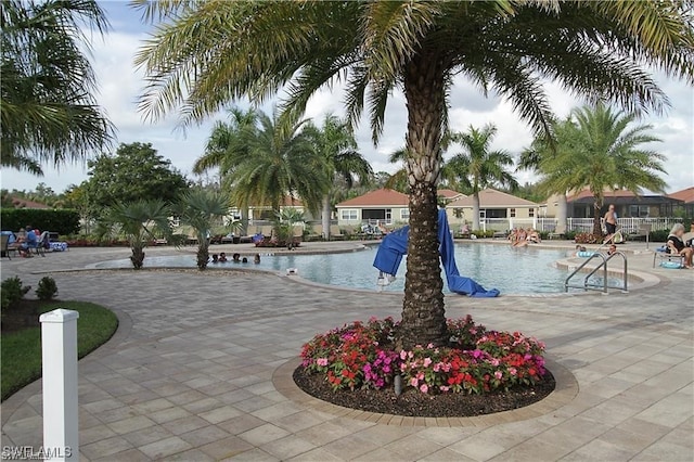 community pool featuring a patio and fence