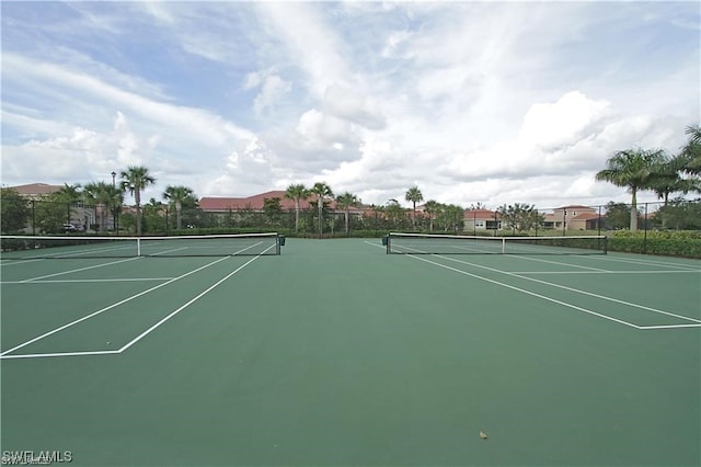 view of sport court featuring fence