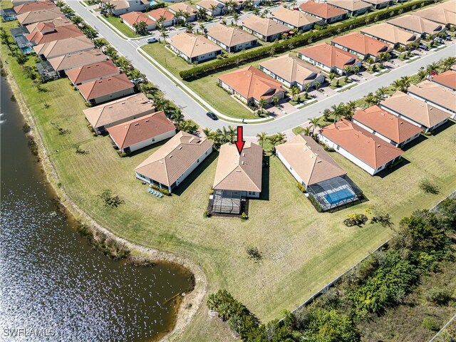 drone / aerial view with a water view and a residential view