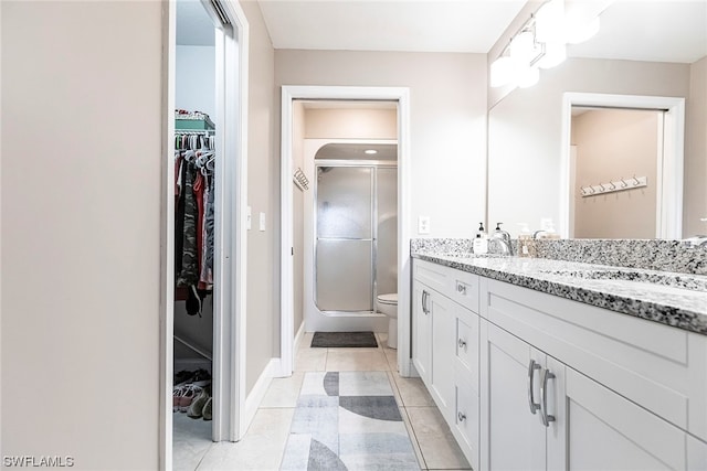 bathroom with tile patterned flooring, vanity, and an enclosed shower