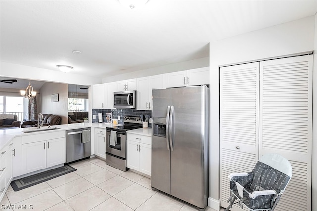 kitchen with white cabinetry, sink, light tile patterned floors, and appliances with stainless steel finishes