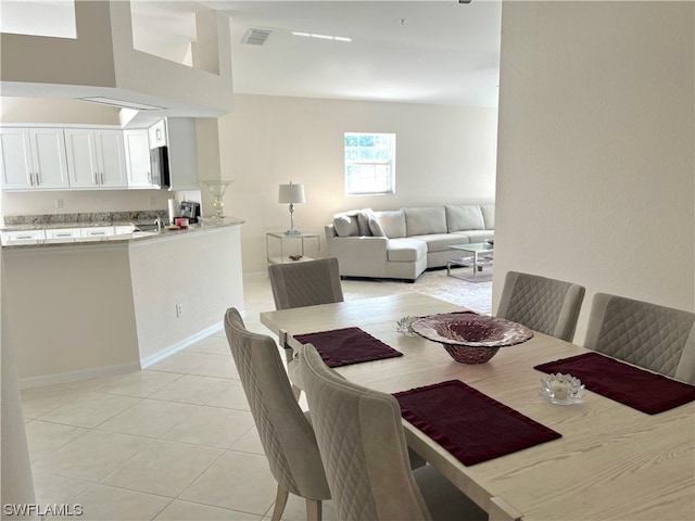 dining area featuring light tile floors