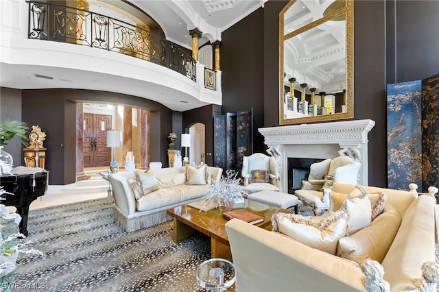 living room with beam ceiling, a towering ceiling, and coffered ceiling