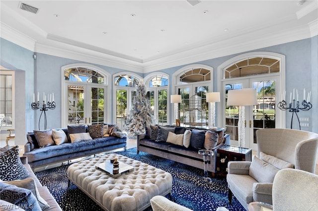 living room featuring french doors, a wealth of natural light, and ornamental molding