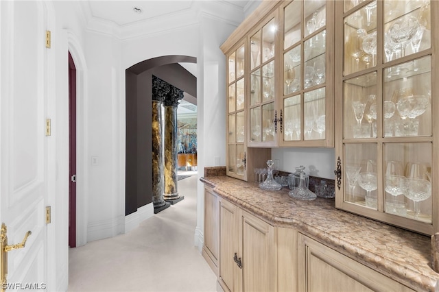 bar featuring crown molding, light brown cabinets, and light colored carpet