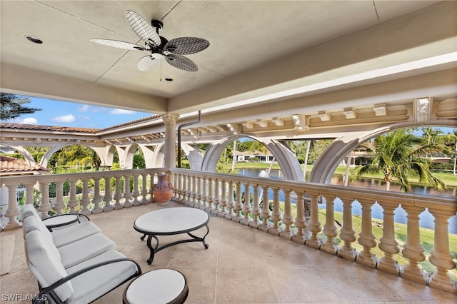 exterior space featuring ceiling fan and a water view